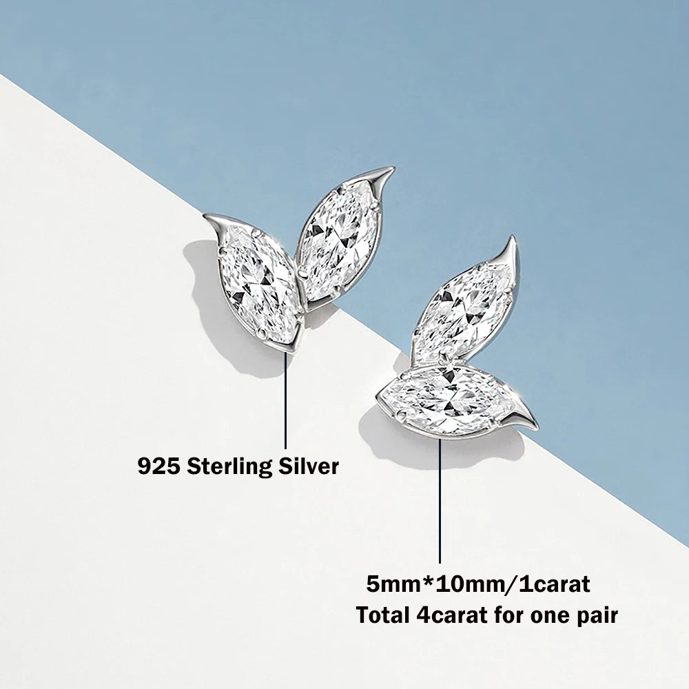 Silver leaf-shaped earrings with diamond-like stones on a light blue and white background.