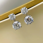 Diamond earrings on a gold and beige background