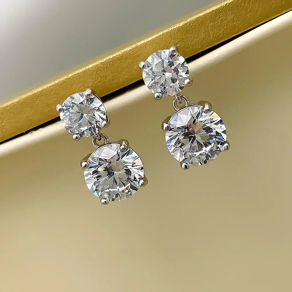 Diamond earrings on a gold and beige background