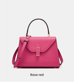 Rose red handbag on a light gray background
