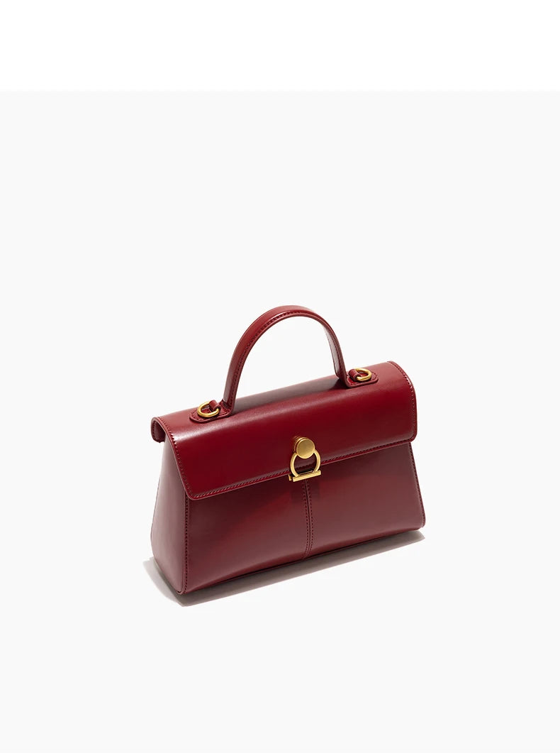 Red handbag with gold accents on a white background