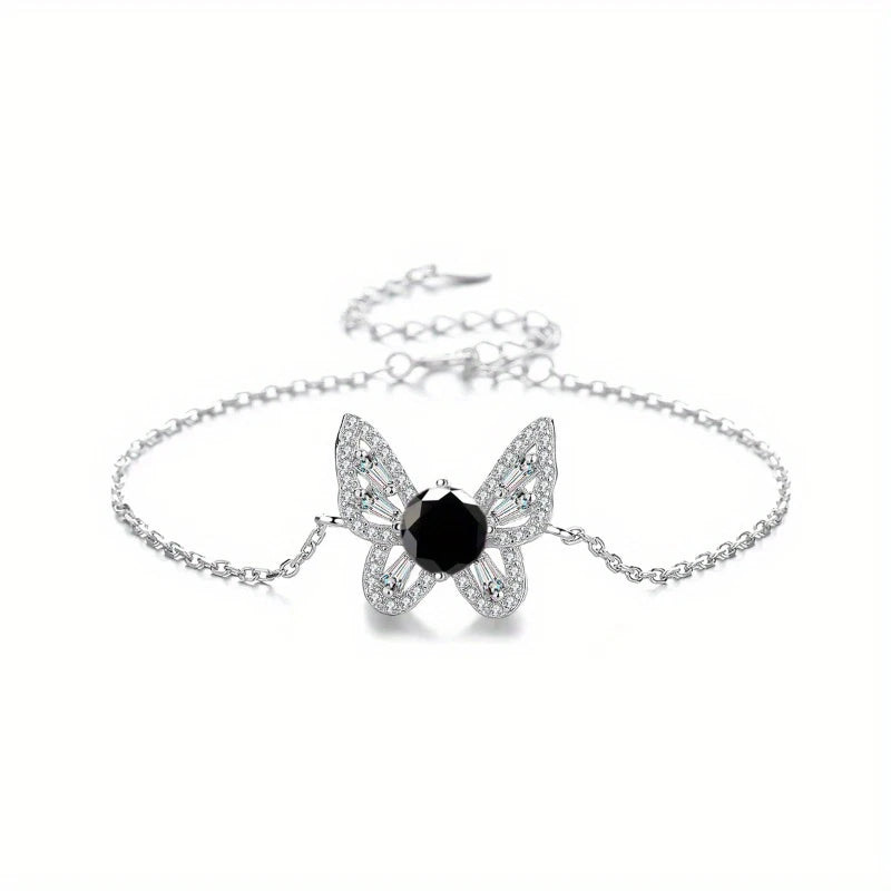 Butterfly-shaped bracelet with a black gemstone on a white background