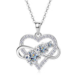 Silver heart-shaped necklace with clear gemstones on a white background