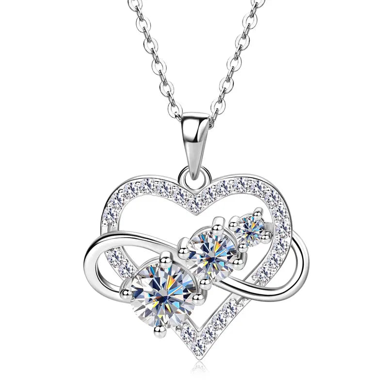Silver heart-shaped necklace with clear gemstones on a white background