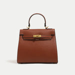 Brown handbag with gold clasp on a white background