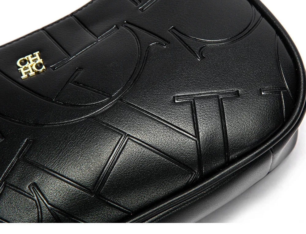 Close-up of a black textured product with gold logo on a white background