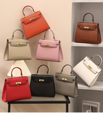 Collection of handbags in various colors displayed on shelves with a neutral background.