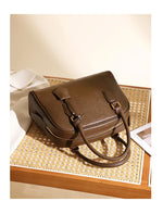 Brown leather handbag on a woven surface