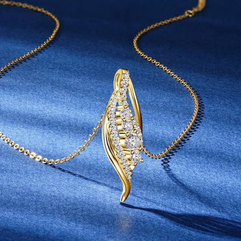 Gold necklace with a decorative pendant on a blue fabric background