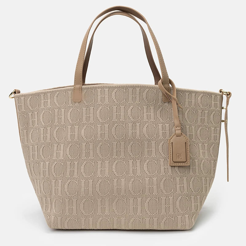 Beige handbag with a monogram pattern on a light gray background