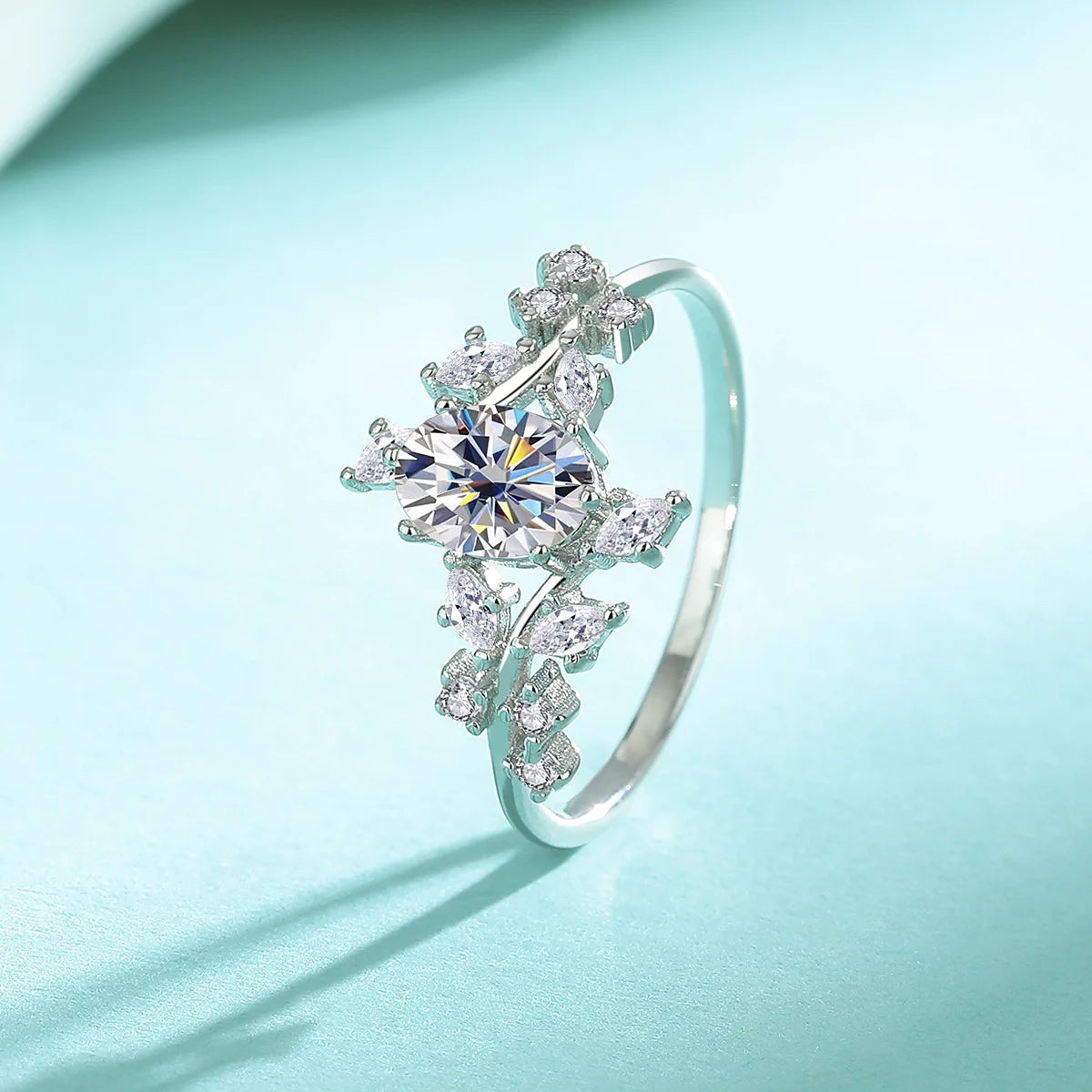 Silver ring with a central gemstone on a light blue background