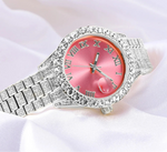 Silver watch with pink face and gemstones on a white background