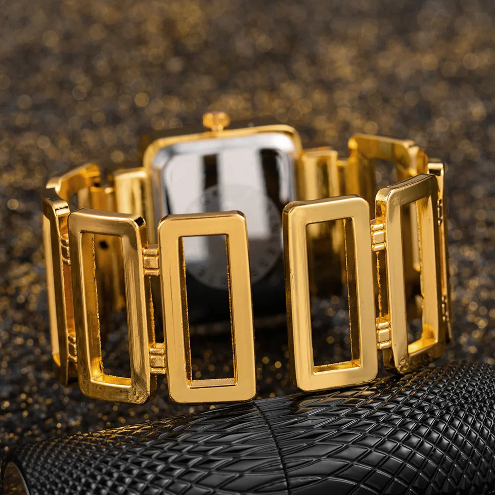 Gold bracelet on a textured black surface with a blurred background
