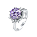 Silver ring with a purple gemstone on a white background