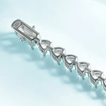 Silver bracelet with a clasp on a light blue background