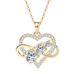 Gold heart-shaped necklace with clear gemstones on a white background