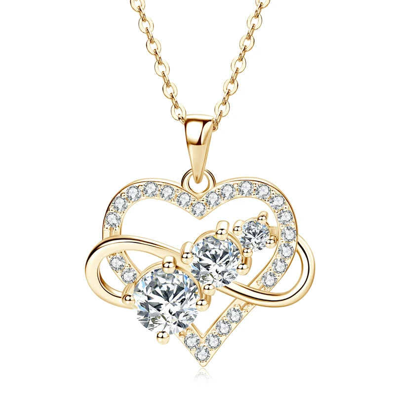 Gold heart-shaped necklace with clear gemstones on a white background