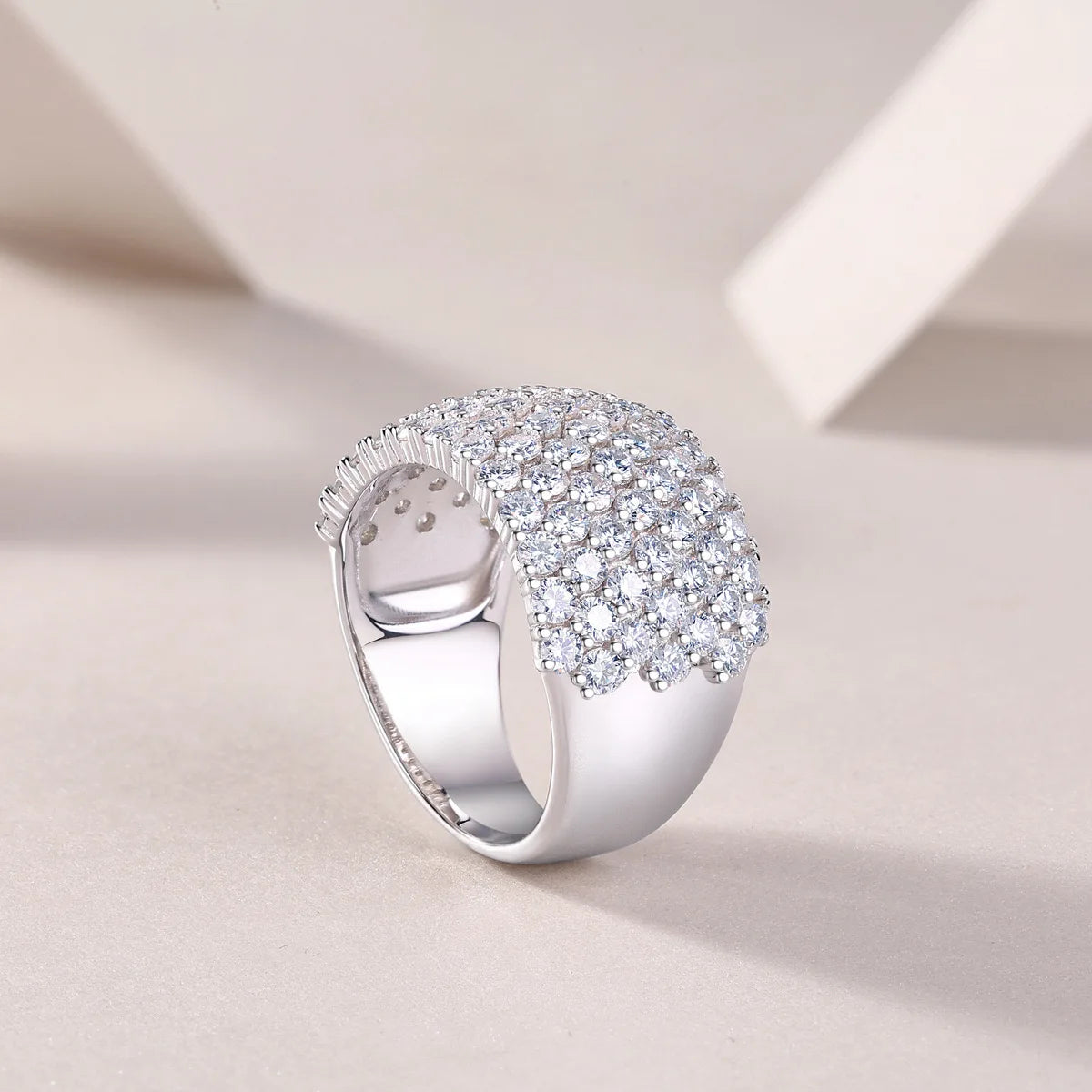 Silver ring with diamond accents on a light background