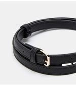 Black leather bracelet with a gold clasp on a white background