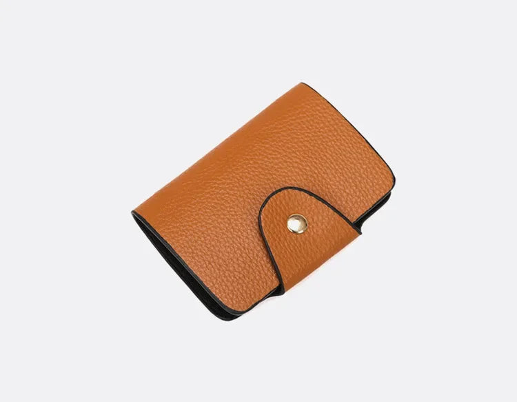 Brown leather cardholder on a light gray background