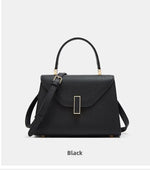 Black handbag with gold accents on a white background