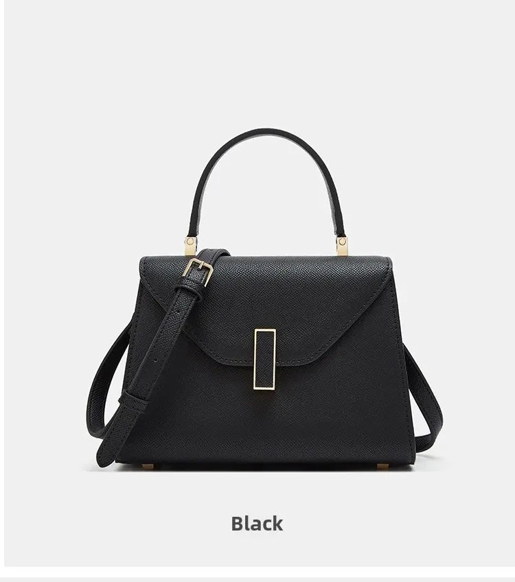 Black handbag with gold accents on a white background