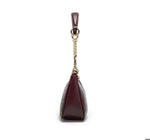 Maroon handbag with gold chain on a white background