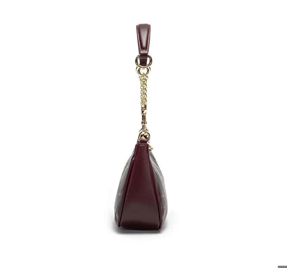 Maroon handbag with gold chain on a white background