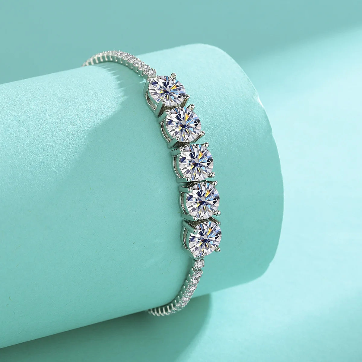 Silver bracelet with clear gemstones on a light blue background