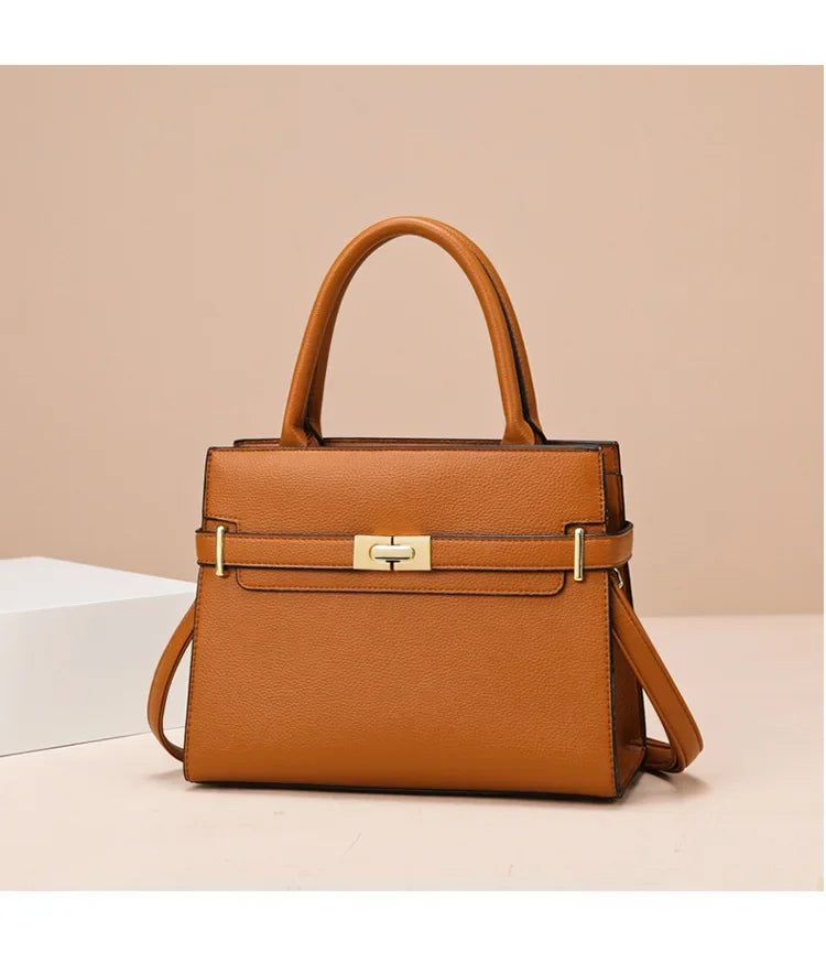Brown handbag with gold accents on a beige background