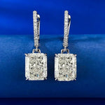 Pair of diamond earrings on a blue background