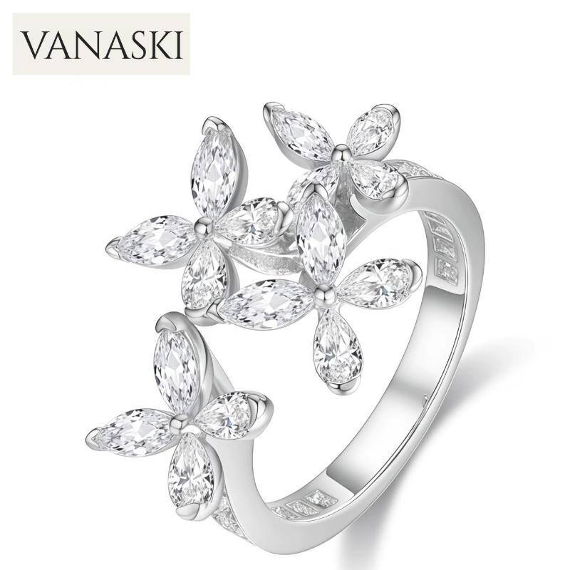 Silver ring with floral design and clear stones on a white background, featuring the Vanaski brand.