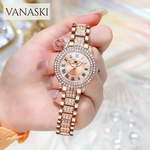 Rose gold watch with diamond accents held by a hand, brand 'VANASKI' visible