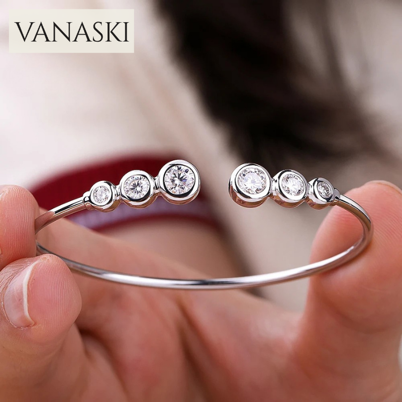 Silver bracelet with diamonds held by a hand, brand 'VANASKI' visible
