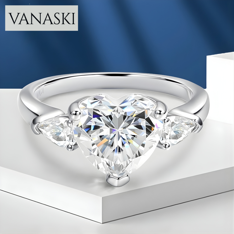 Heart-shaped diamond ring with Vanaski branding on a blue and white background