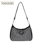 Black handbag with rhinestone details on a white background, featuring the Vanaski brand.
