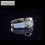 Vanaski diamond ring with a large central gemstone and smaller ones on a black background