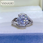 Silver ring with a large diamond on a blue cushion, branded 'VANASKI'.