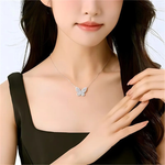 Butterfly necklace worn by a model with a plain background