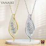 Two leaf-shaped necklaces, one gold and one silver, on a beige background with 'VANASKI' branding.