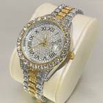 Luxury watch with gold and silver band on a white cushion