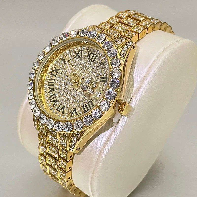 Gold watch with diamond-studded face and band on a white cushion